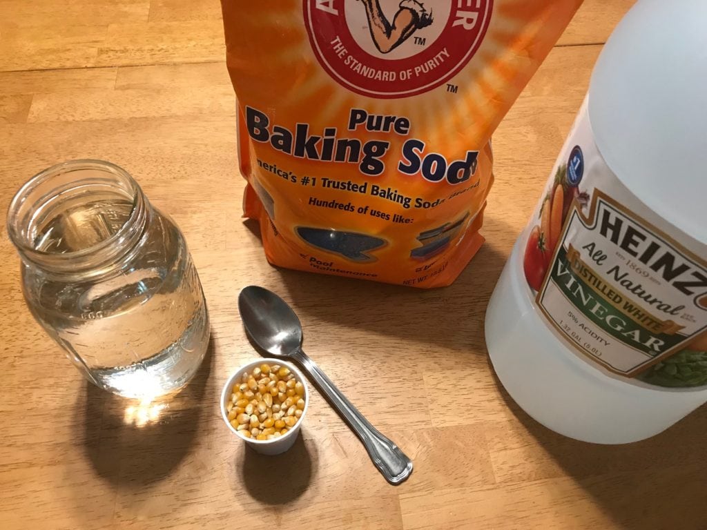 baking soda vinegar corn spoon and a jar