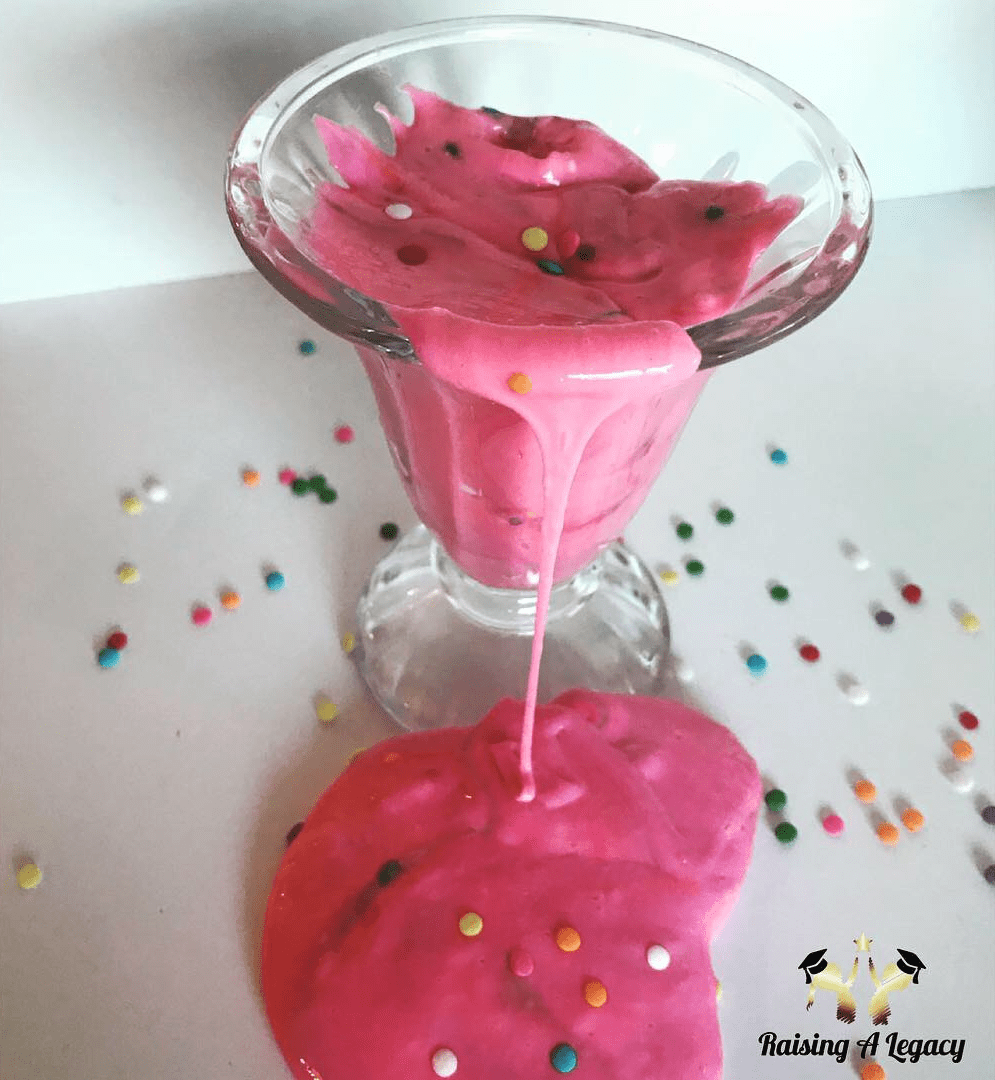 pink slime with sprinkles flowing out of a glass